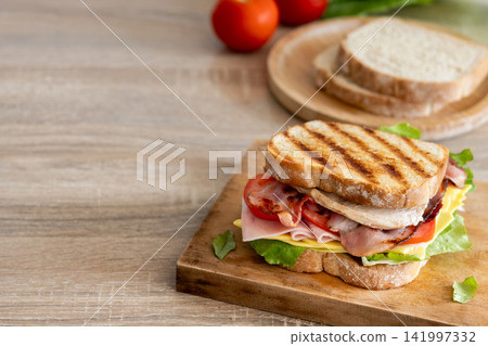 Grilled club sandwich with bacon and ham Grilled club sandwich with bacon and ham 141997332