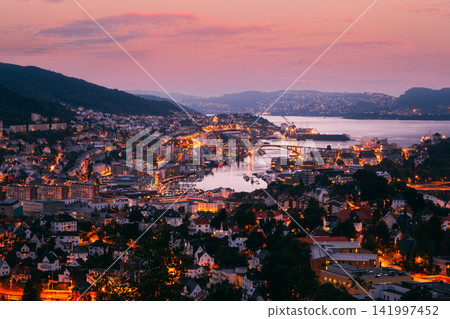 Bergen cityscape and harbor under a soft purple sunset sky. 141997452