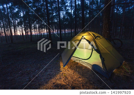 Light in a tourist tent at night Light in a tourist tent at night 141997920