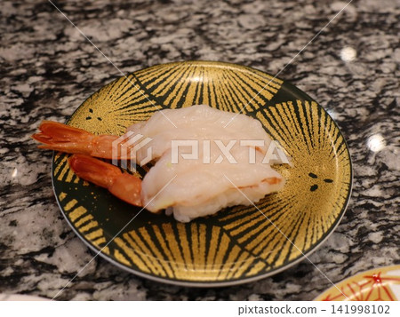Sweet shrimp nigiri sushi, two pieces of shrimp served on a gold-decorated Japanese plate. Sweet shrimp nigiri sushi, two pieces of shrimp served on a gold-decorated Japanese plate. 141998102