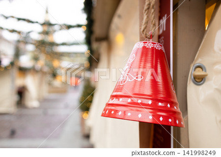 Christmas candy cane ornament hanging at festive outdoor market Christmas candy cane ornament hanging at festive outdoor market 141998249