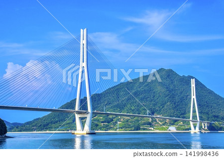 Tatara Bridge as seen from Omishima Island on the Shimanami Kaido. Tatara Bridge as seen from Omishima Island on the Shimanami Kaido. 141998436