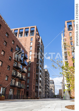 Contemporary urban apartment complex with brick facade architecture Contemporary urban apartment complex with brick facade architecture 141998466