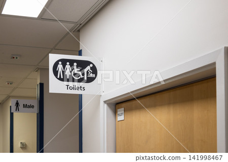 Public toilet directional sign hanging Public toilet directional sign hanging 141998467