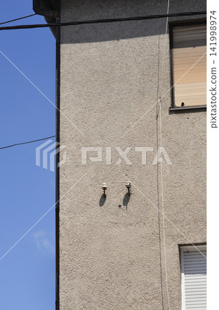 Old ceramic electrical insulators on a building facade 141998974