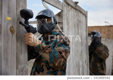 Portrait of a soldier practice with weapons on a training field Portrait of a soldier practice with weapons on a training field 141999392