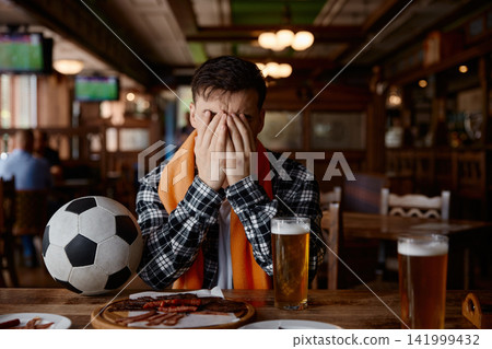 Football fan displays sorrow after team defeat Football fan displays sorrow after team defeat 141999432
