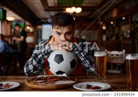 Football fan displays sorrow after team defeat Football fan displays sorrow after team defeat 141999434