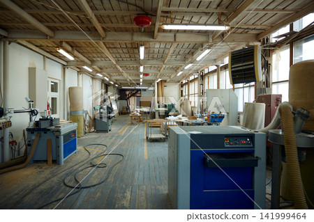 Industrial workshop scene. Abandoned woodworking plant showcasing aged equipment and tools Industrial workshop scene. Abandoned woodworking plant showcasing aged equipment and tools 141999464