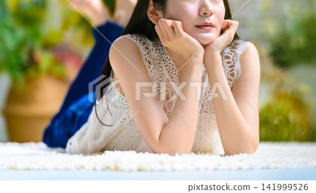 The face of a woman wearing a white lace top The face of a woman wearing a white lace top 141999526
