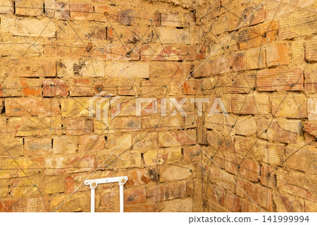 Weathered Brick Wall with Geometric Wire Pattern Weathered Brick Wall with Geometric Wire Pattern 141999994