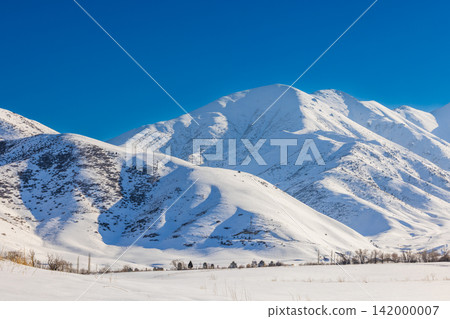 Majestic Snow-Covered Mountains Under Clear Blue Sky 142000007