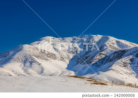 Snow-Covered Mountains Under Clear Blue Sky in Kyrgyzstan Snow-Covered Mountains Under Clear Blue Sky in Kyrgyzstan 142000008