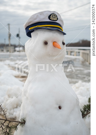 Snowman wearing a captain hat in winter 142000374