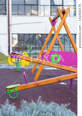 Colorful playground equipment in a modern courtyard 142000376
