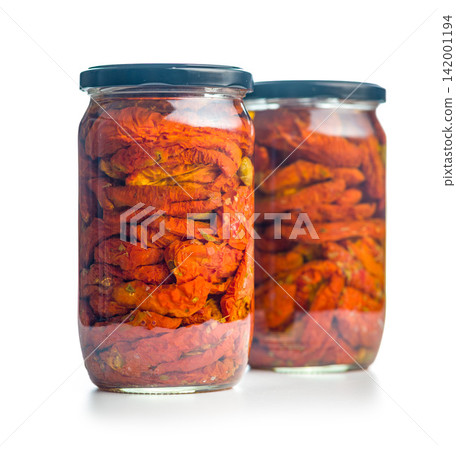 Jar Of Sun-Dried Tomatoes Preserved In Oil Close-Up On White Background 142001194