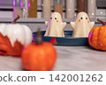Whimsical halloween ghost jellies with miniature pumpkins on a marble surface 142001262
