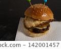 Homemade cheeseburger with fried egg and caramelized onions, close up shot 142001457