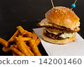 Gourmet Burger with Fried Egg, Cheese, Caramelized Onion and Fries 142001460