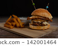Cheeseburger with Fried Egg, Caramelized Onions and Crispy Fries 142001464