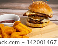 Double Hamburger with Egg and Cheese on Wooden Board with Fries 142001467