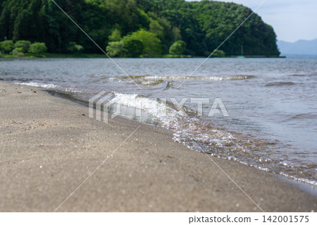 Waves crashing onto the shore of Lake Inawashiro Waves crashing onto the shore of Lake Inawashiro 142001575