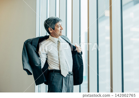 辦公室裡穿著西裝外套的高級商務人士 辦公室裡穿著西裝外套的高級商務人士 142002765