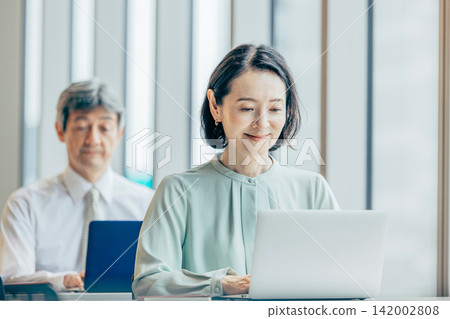 Business person working at a computer in the office Business person working at a computer in the office 142002808