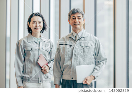 Two engineers in work clothes Two engineers in work clothes 142002829