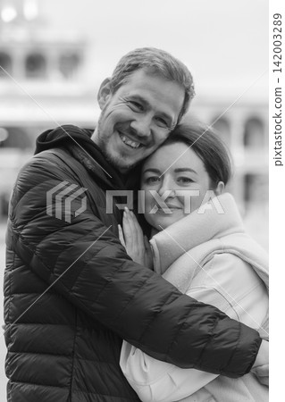 Affectionate embracing outdoors with a soft city background, expressing, care, emotional warmth and genuine connection for brands. Affectionate embracing outdoors with a soft city background, expressing, care, emotional warmth and genuine connection for brands. 142003289