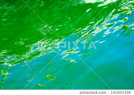 Green reflected on the surface of the water Green reflected on the surface of the water 142003386