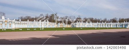 Exterior view of Catherine Palace featuring intricate architectural details and well-maintained gardens in Tsarskoye Selo, Russia with a clear sky Exterior view of Catherine Palace featuring intricate architectural details and well-maintained gardens in Tsarskoye Selo, Russia with a clear sky 142003498