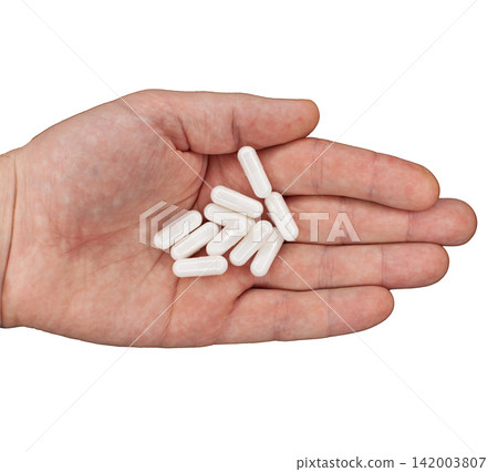 Hand displays several white capsules resting on the palm, representing dietary supplements or medication in a clear and focused view Hand displays several white capsules resting on the palm, representing dietary supplements or medication in a clear and focused view 142003807