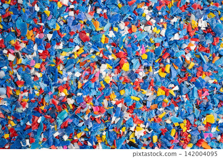 Plastic colorful pieces recycling shredded for industrial use. Plastic colorful pieces recycling shredded for industrial use. 142004095