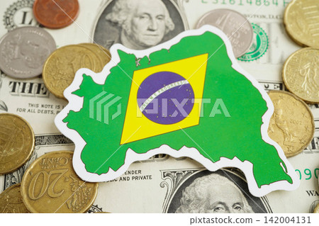 Brazil flag on coin and banknote money, finance trading investment business currency. Brazil flag on coin and banknote money, finance trading investment business currency. 142004131