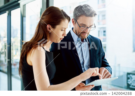 Office, training and business people with tablet for mature man or ceo and female employee for discussion. Tech, communication and intern with mentor for coaching, learning and journalism internship Office, training and business people with tablet for mature man or ceo and female employee for discussion. Tech, communication and intern with mentor for coaching, learning and journalism internship 142004288
