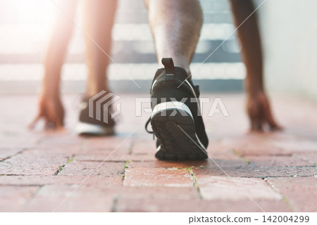 Feet, sport and runner start on pavement with person and athlete for running and jog. Shoes, wellness, fitness with cardio, workout and race training on concrete for marathon outdoor for health Feet, sport and runner start on pavement with person and athlete for running and jog. Shoes, wellness, fitness with cardio, workout and race training on concrete for marathon outdoor for health 142004299