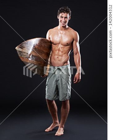 Young surfer and vintage board in portrait and dark with body, stomach and strong or healthy. Male wave rider, backdrop or wood or retro accessory in studio for sports, fitness or confidence at night Young surfer and vintage board in portrait and dark with body, stomach and strong or healthy. Male wave rider, backdrop or wood or retro accessory in studio for sports, fitness or confidence at night 142004312