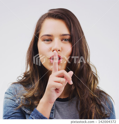 Woman, portrait and finger with rumor, studio and silence for mystery announcement. Model, gossip and hush with secret, whisper and gesture for news or noise with confidential on white background Woman, portrait and finger with rumor, studio and silence for mystery announcement. Model, gossip and hush with secret, whisper and gesture for news or noise with confidential on white background 142004372