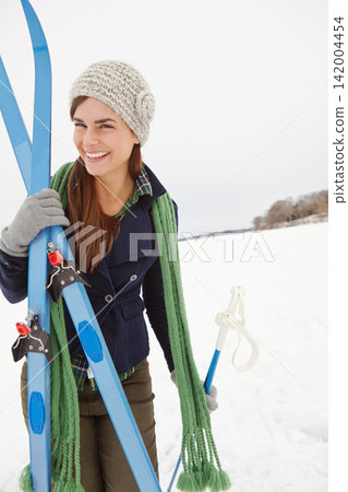 Woman, ski and snow with portrait on vacation for fitness, outdoor and ready for adventure with excited smile. Person, happy and equipment for winter sports in nature at holiday resort in Switzerland Woman, ski and snow with portrait on vacation for fitness, outdoor and ready for adventure with excited smile. Person, happy and equipment for winter sports in nature at holiday resort in Switzerland 142004454