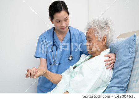 Asian doctor checking and treat elderly woman patient health in hospital. Asian doctor checking and treat elderly woman patient health in hospital. 142004633