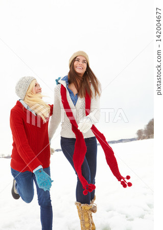 Women, friendship and snow in winter for vacation is Alaska for Christmas, festive and travel for bonding. Female people, play and laugh with hug, happiness and love for holiday, break or retreat Women, friendship and snow in winter for vacation is Alaska for Christmas, festive and travel for bonding. Female people, play and laugh with hug, happiness and love for holiday, break or retreat 142004677