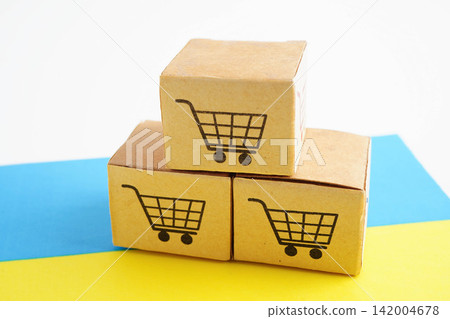 Online shopping, Shopping cart box on Ukraine flag, import export, finance commerce. Online shopping, Shopping cart box on Ukraine flag, import export, finance commerce. 142004678
