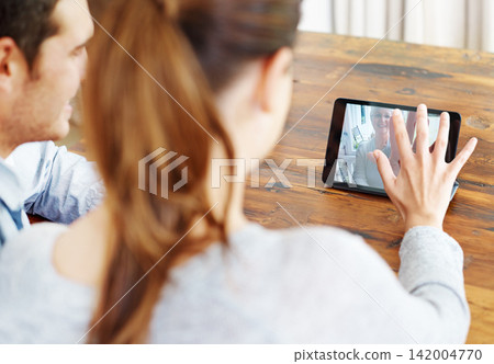 Couple, online and video call with tablet in house for communication, talking and discussion long distance. Psychologist, man and woman for telehealth, virtual therapy and marriage counseling Couple, online and video call with tablet in house for communication, talking and discussion long distance. Psychologist, man and woman for telehealth, virtual therapy and marriage counseling 142004770