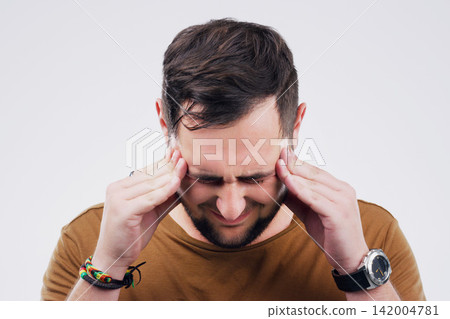 Man, headache and pain in studio, crisis and burnout or anxiety for mental health on gray background. Male person, worry and sad for fail or mistake, migraine and distress on mockup space or upset Man, headache and pain in studio, crisis and burnout or anxiety for mental health on gray background. Male person, worry and sad for fail or mistake, migraine and distress on mockup space or upset 142004781