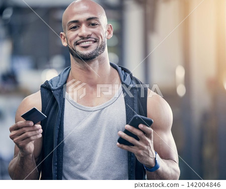 Credit card, phone and portrait with bodybuilder man in gym for strength training or workout. Exercise, smile and wellness with happy athlete in health club for ecommerce or online shopping Credit card, phone and portrait with bodybuilder man in gym for strength training or workout. Exercise, smile and wellness with happy athlete in health club for ecommerce or online shopping 142004846