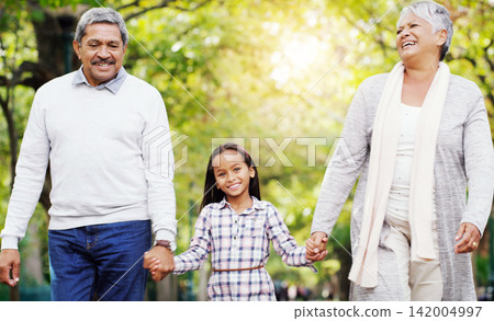 Park, walk and grandparents holding hands with child, smile and bonding on outdoor adventure together. Old man, woman and girl in nature with love, support and happy family in garden with grandchild. Park, walk and grandparents holding hands with child, smile and bonding on outdoor adventure together. Old man, woman and girl in nature with love, support and happy family in garden with grandchild. 142004997