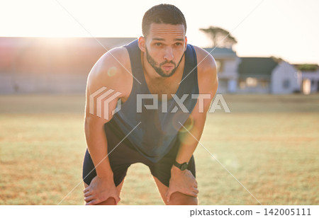 Man, tired and breathing outdoor with fitness for exercise break, workout and training on sports field. Athlete, person and runner with relax, overworked and healthy body with wellness on stadium Man, tired and breathing outdoor with fitness for exercise break, workout and training on sports field. Athlete, person and runner with relax, overworked and healthy body with wellness on stadium 142005111