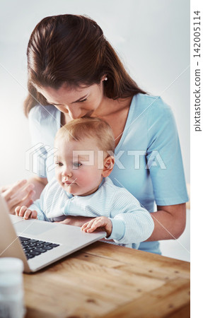 Mom, baby and desk with laptop in house for child development, video and mothers day with kiss on head. Woman, kid and table with technology in home for learning, entertainment and growth with 142005114