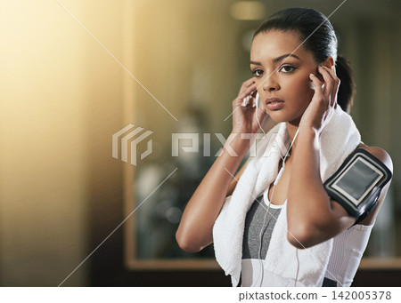 Woman, earphones and exercise arm band or cellphone pouch or fitness app, music or song. Female person, listening and digital wellness or gym podcast for health workout or audio, online or training Woman, earphones and exercise arm band or cellphone pouch or fitness app, music or song. Female person, listening and digital wellness or gym podcast for health workout or audio, online or training 142005378